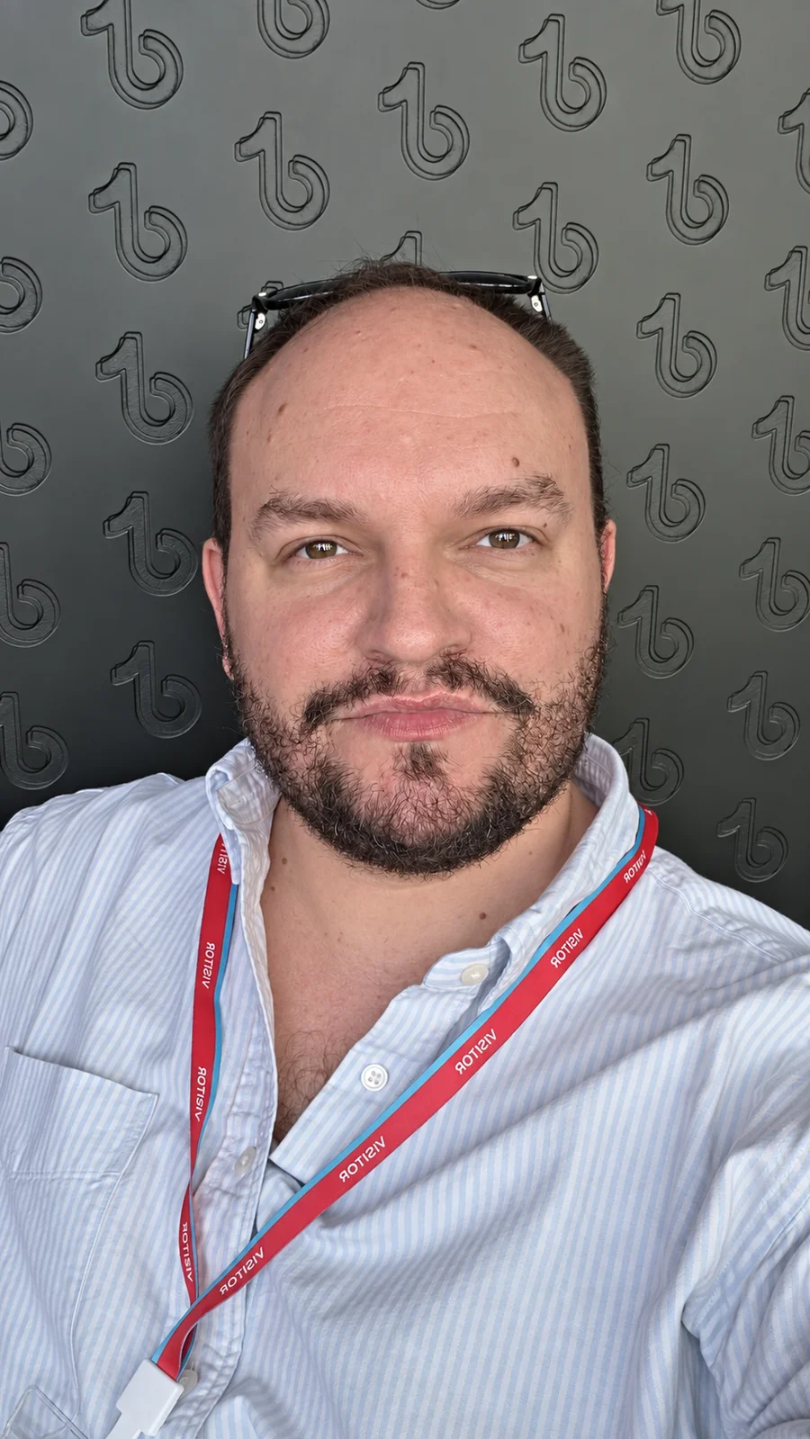 Sir Chris seated in front of a TikTok-patterned background